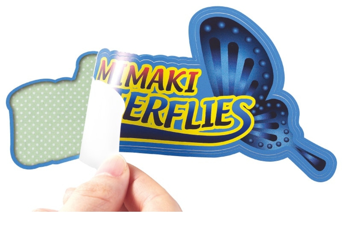 A die cut sticker of a butterfly being peeled by a hand