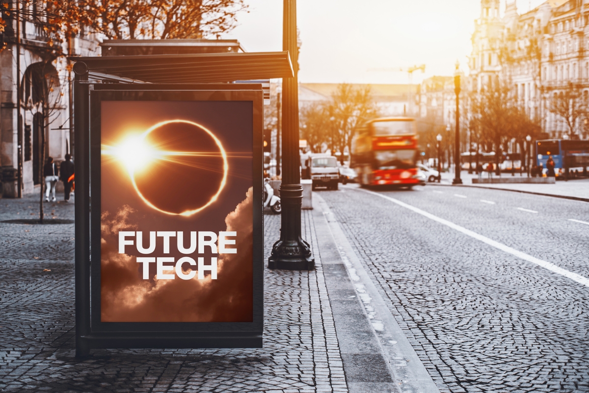 A bus stop in an urban setting showing an advertisement for Future Tech.