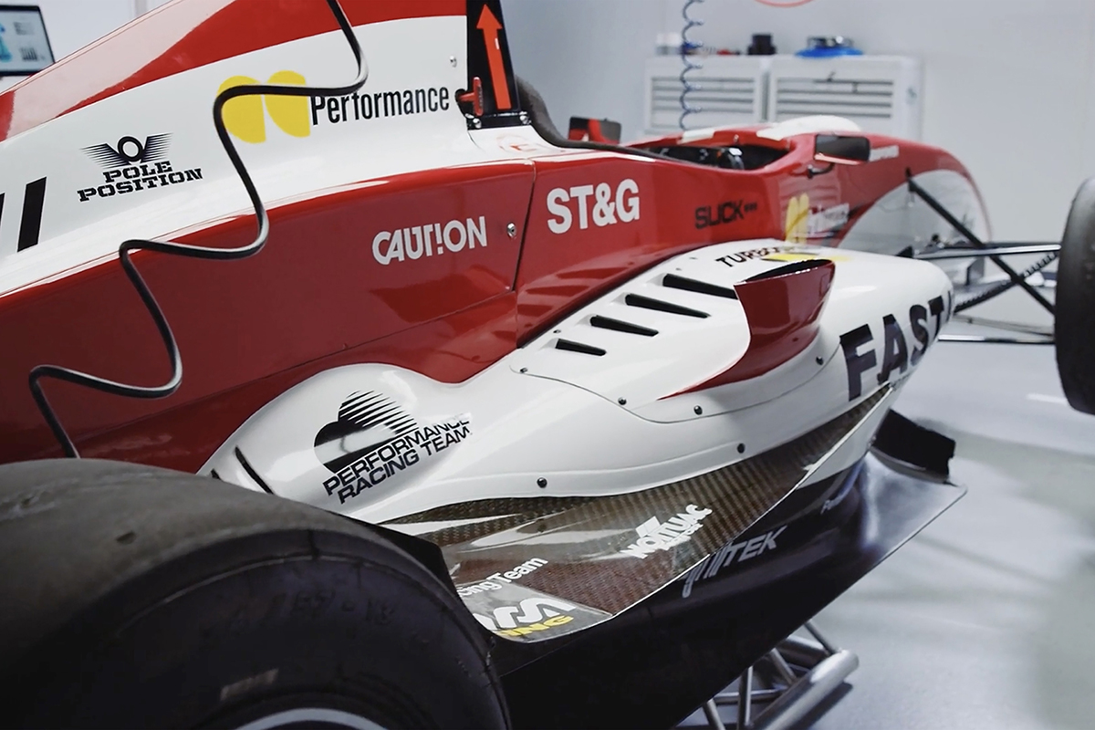 A red and white race car featuring digitally printed vinyl graphics