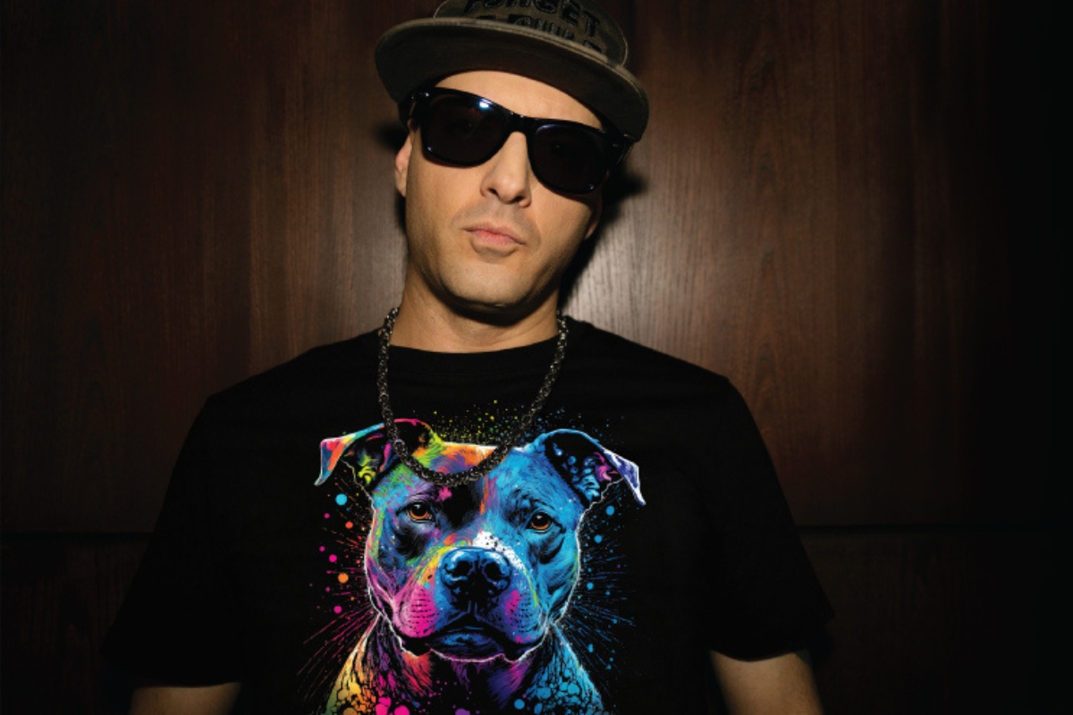 Man wearing a black t-shirt featuring an intricate and brightly coloured Mimaki DTF printed dog design