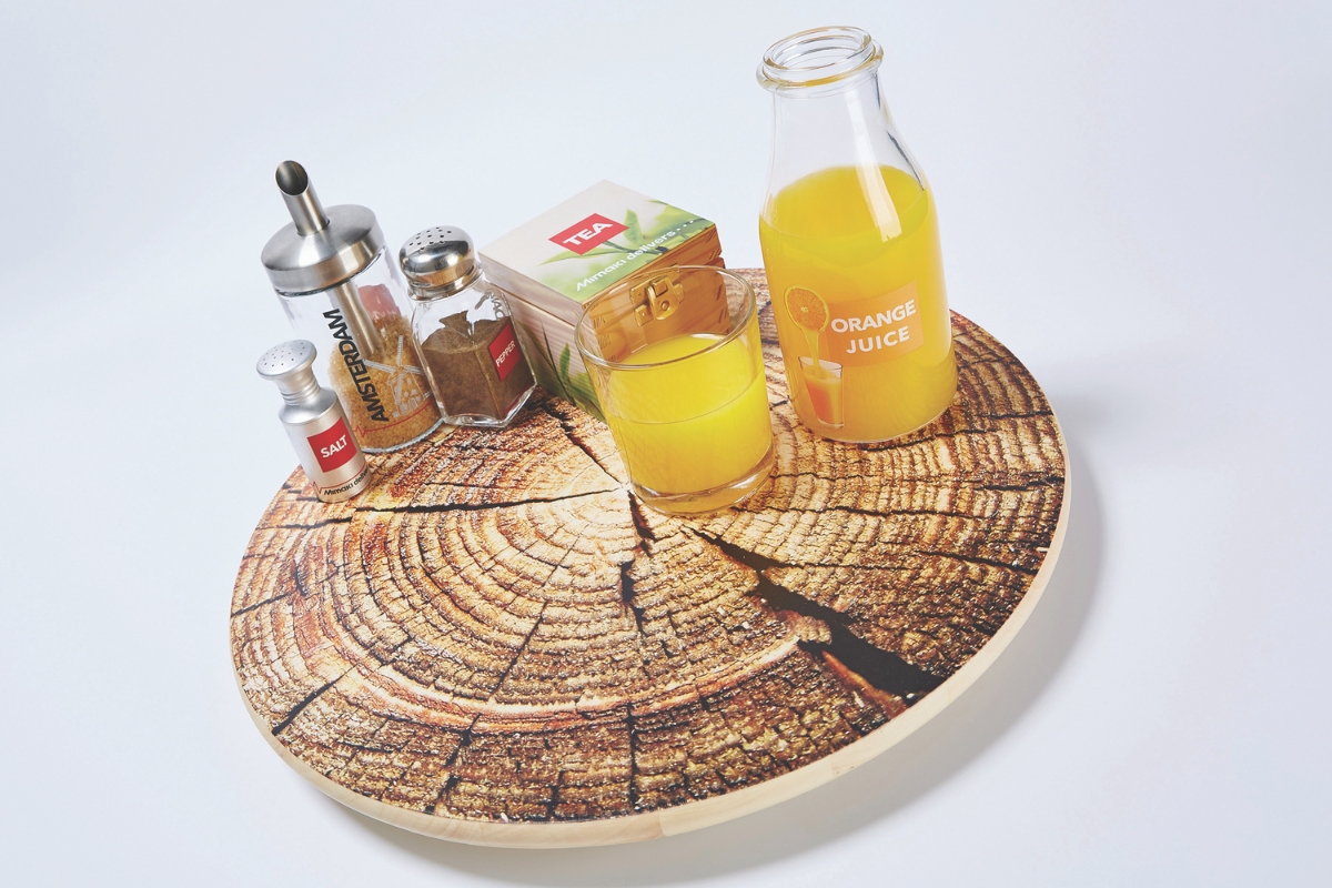 A UV printed wooden tray deigned to look like a cut log, with a series of cartons and glasswear all bearing UV printed logos.