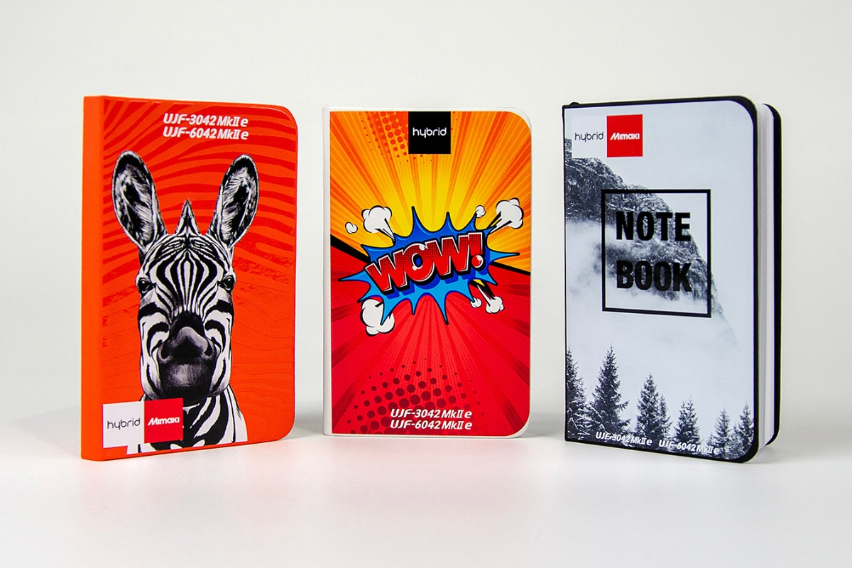 Three brightly coloured notebooks all printed with the Mimaki UJF printer