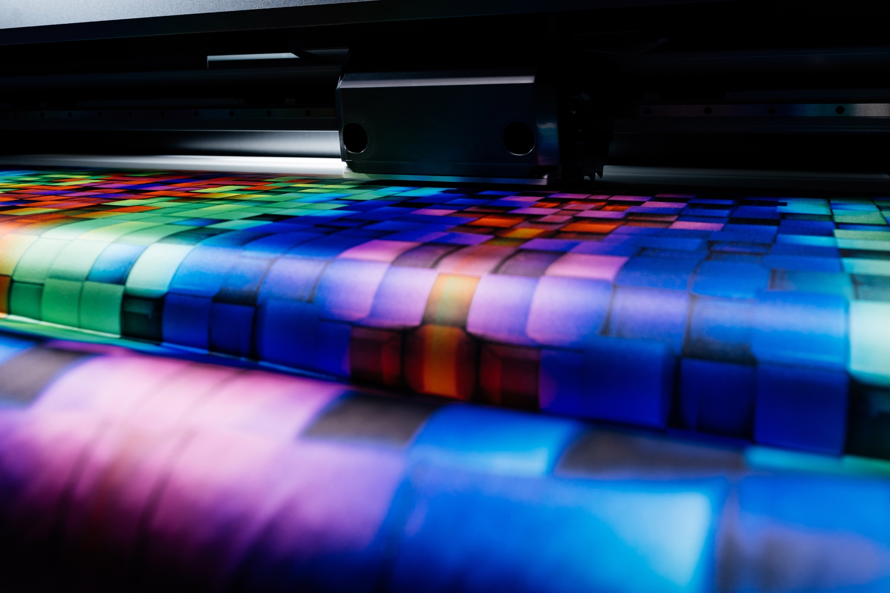 A Mimaki textile printer printing a bright coloured design onto cotton