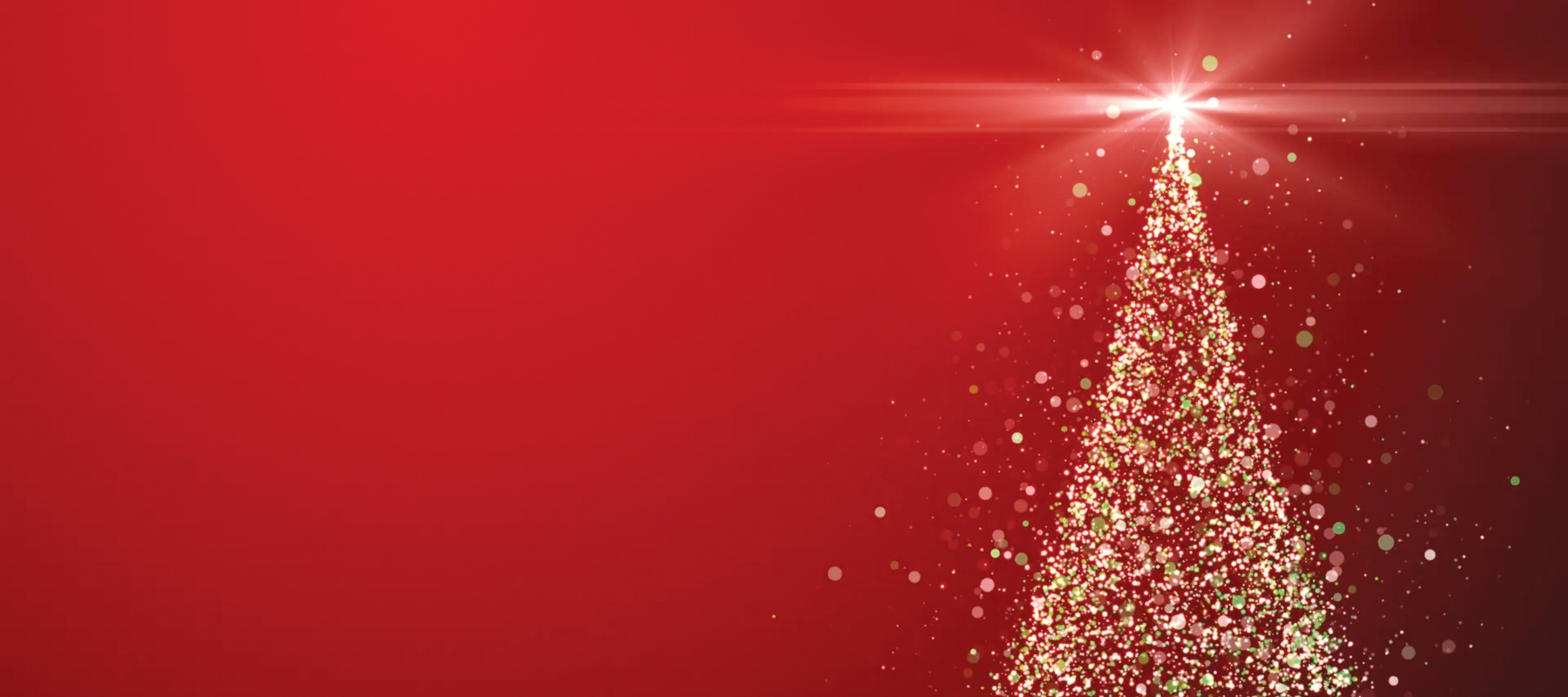 A brightly illuminated christmas tree on a red background for Hybrid's Christmas web page