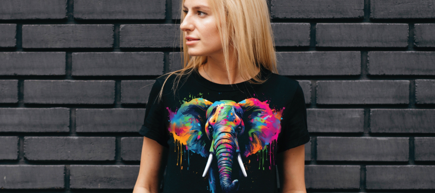 An image of a person wearing a Mimaki DTF printed t-shirt with a brightly coloured graphic on the front